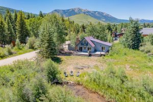 Crested Butte real estate - exterior aerial image of 251 Lower Allen Road, Crested Butte. Two story home sitting along Cement Creek.