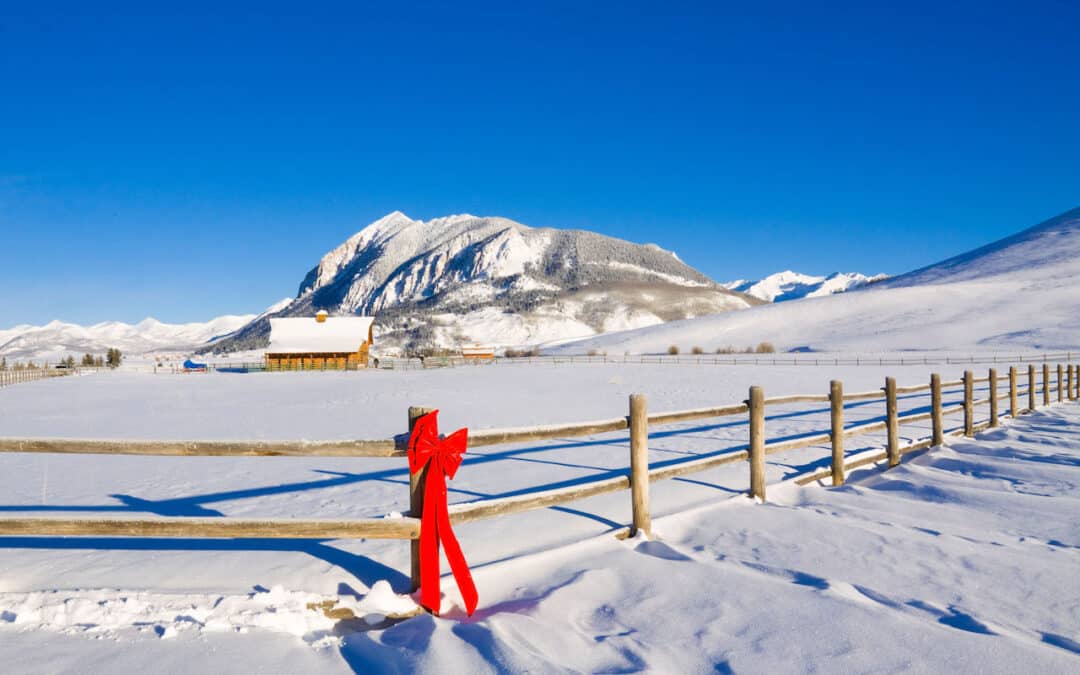 Winter Landscape - Mt. Crested Butte in background, wooden fence with red bow