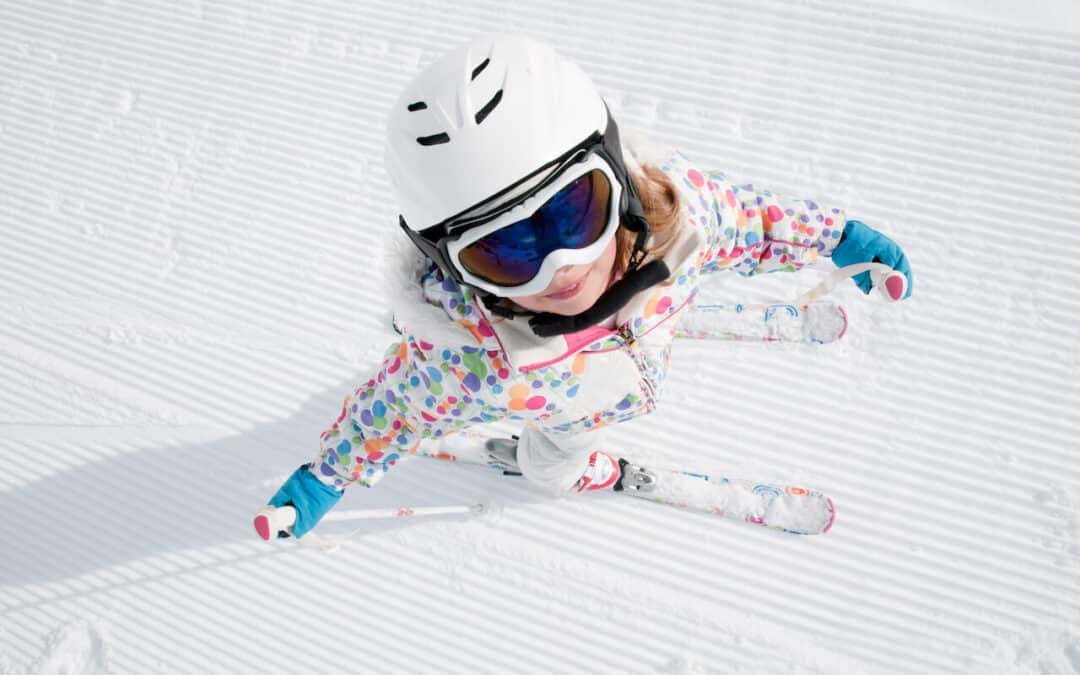 Crested Butte Real Estate - Spring Skiing. Little girl on skis on a groomed run.