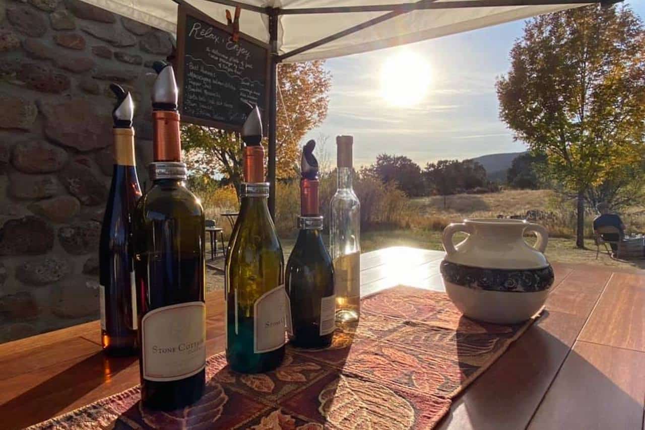 Crested Butte real estate - image of wine bottles on bar with sunset and fall leaves in background