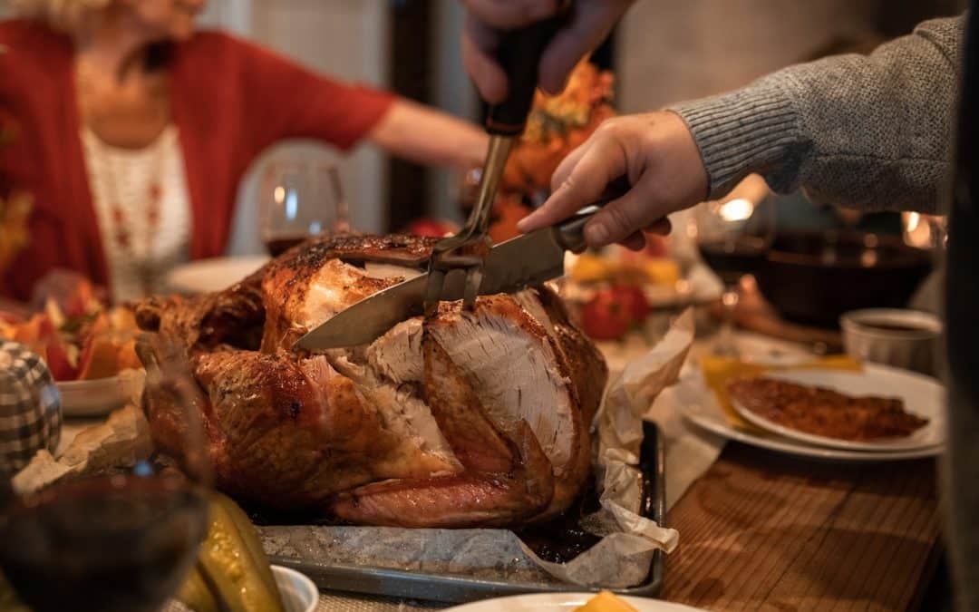 Crested Butte real estate - thanksgiving dinner, man carving turkey.