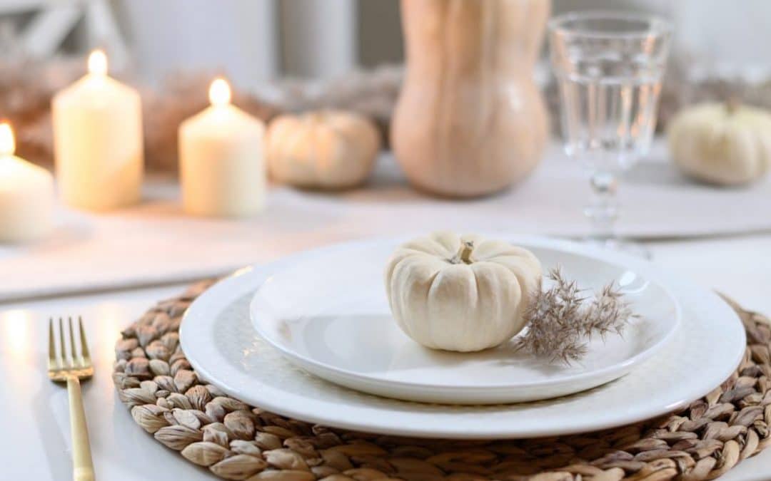 Crested Butte real estate - holiday season table decor ideas: Thanksgiving table with candles, white mini pumpkin, butternut squash & white plates.