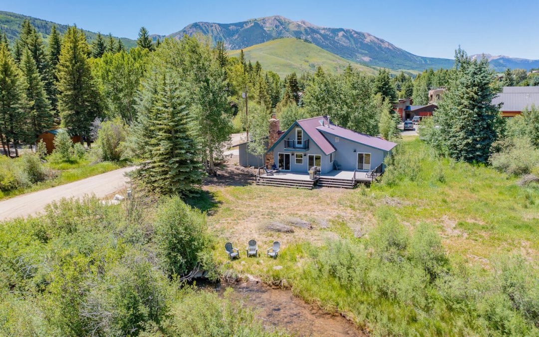 Crested Butte real estate - exterior aerial image of 251 Lower Allen Road, Crested Butte. Two story home sitting along Cement Creek.